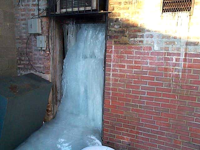 Water damage mitigation in progress with drying equipment on frozen cascade